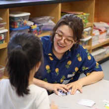 CEAS Volunteer interacting with a kindergarten student